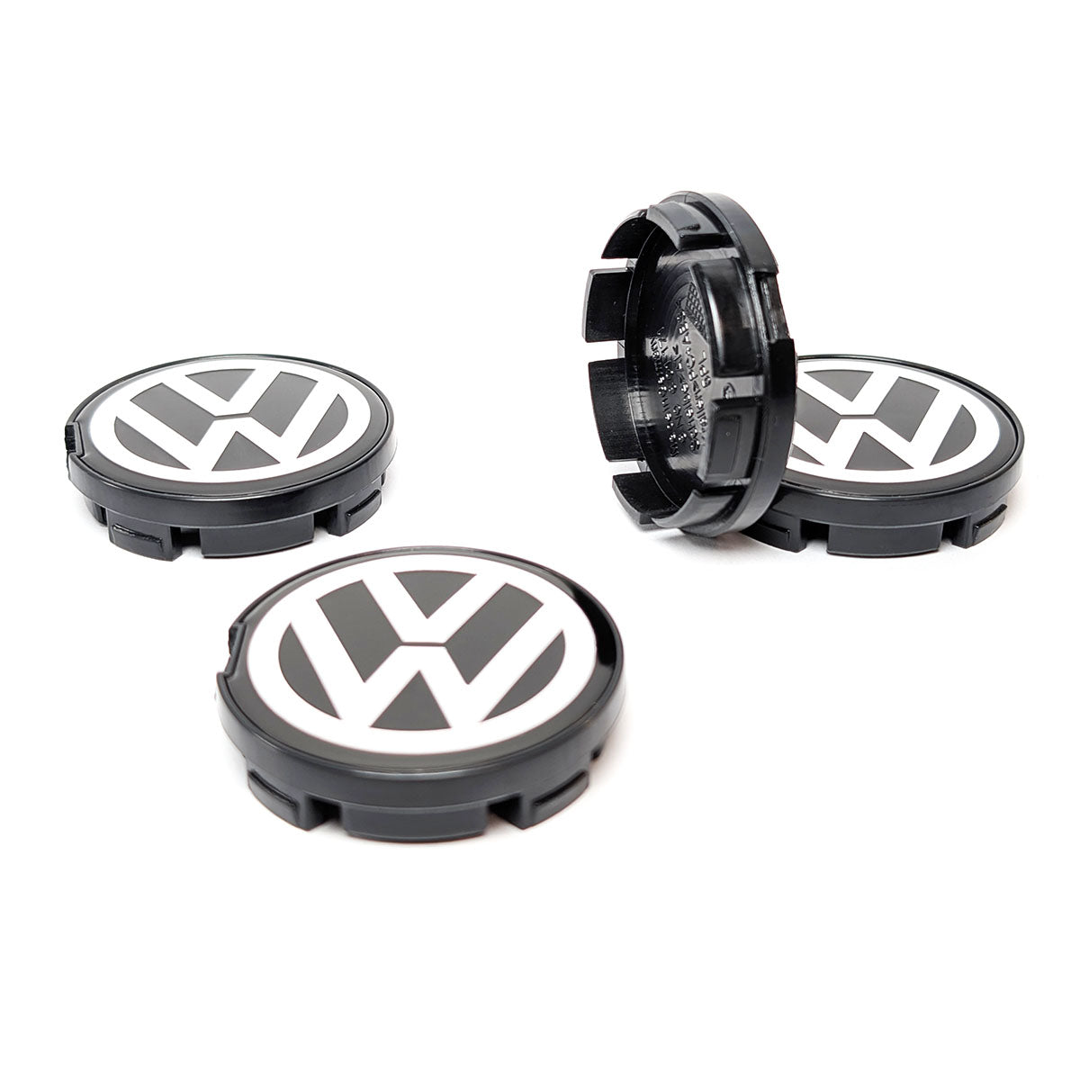 VW Nabenkappen Set (4 Stück) in Schwarz und Weiß/Chrom, Seitenansicht und Vorderansicht. Ersatzteilnummer 6N0601171.